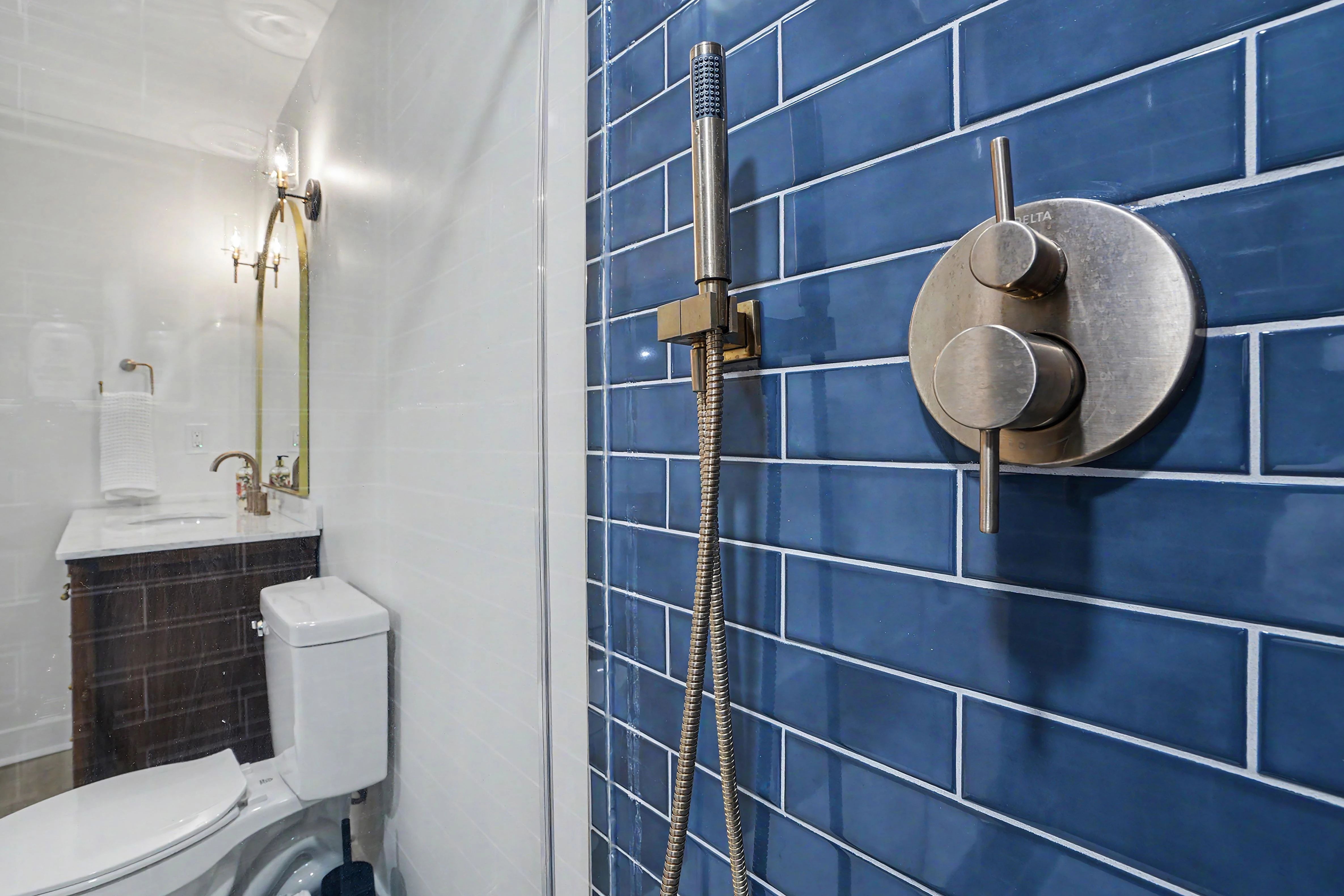 Custom tiled shower interior with handheld sprayer in a Prairie Village basement remodel bathroom